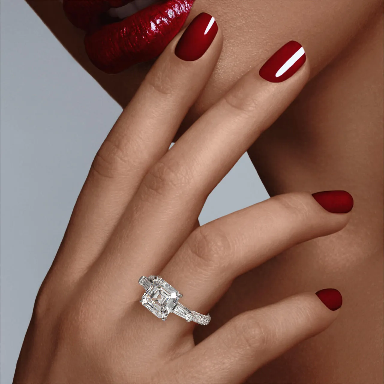 ASSCHER CUT DIAMOND ENGAGEMENT RING WITH A BAGUETTE FLANK THREE PHASES TRIPLE PAVE SETTING IN PLATINUM
