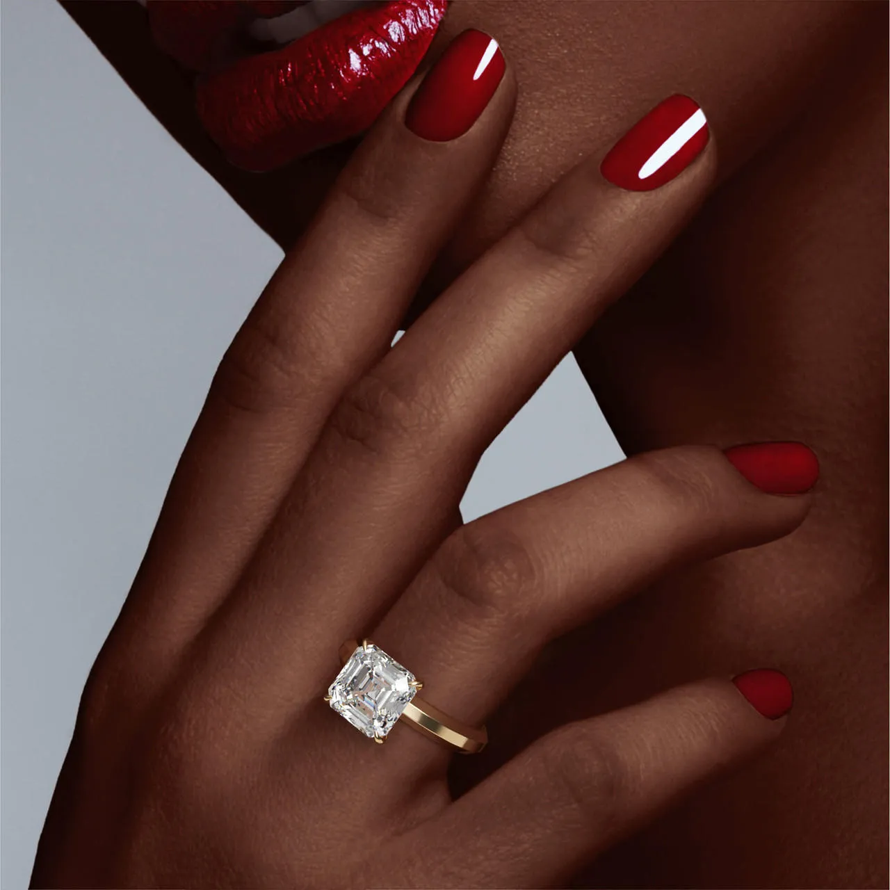 ASSCHER CUT DIAMOND ENGAGEMENT RING WITH A CLASSIC 4 PRONG THREE PHASES SETTING IN 18K YELLOW GOLD