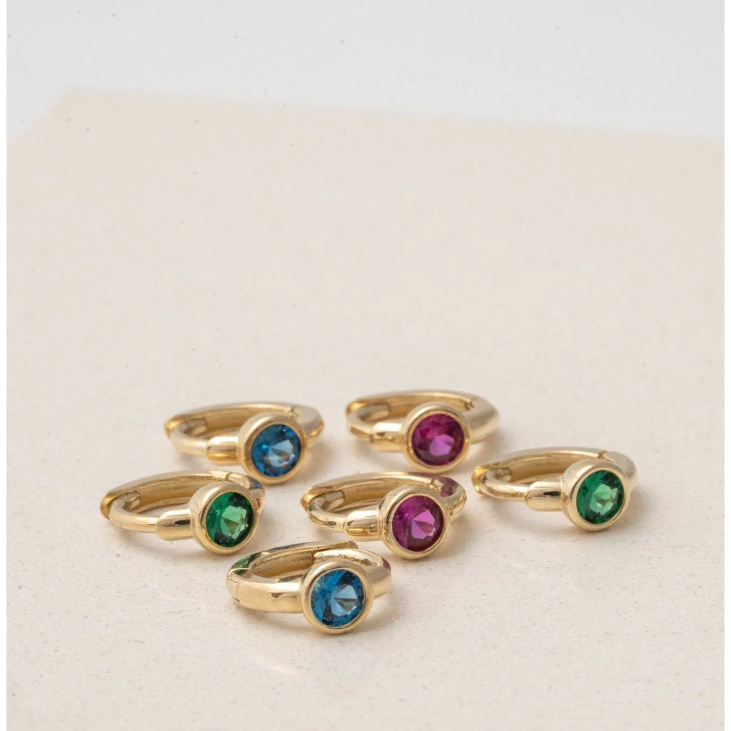 Bezel Set Emerald Huggie in  Gold