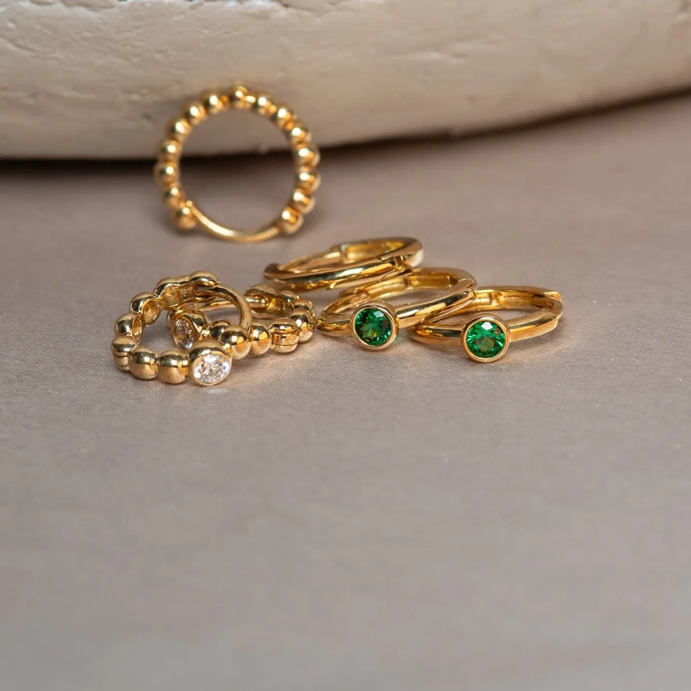 Bezel Set Emerald Huggie in  Gold