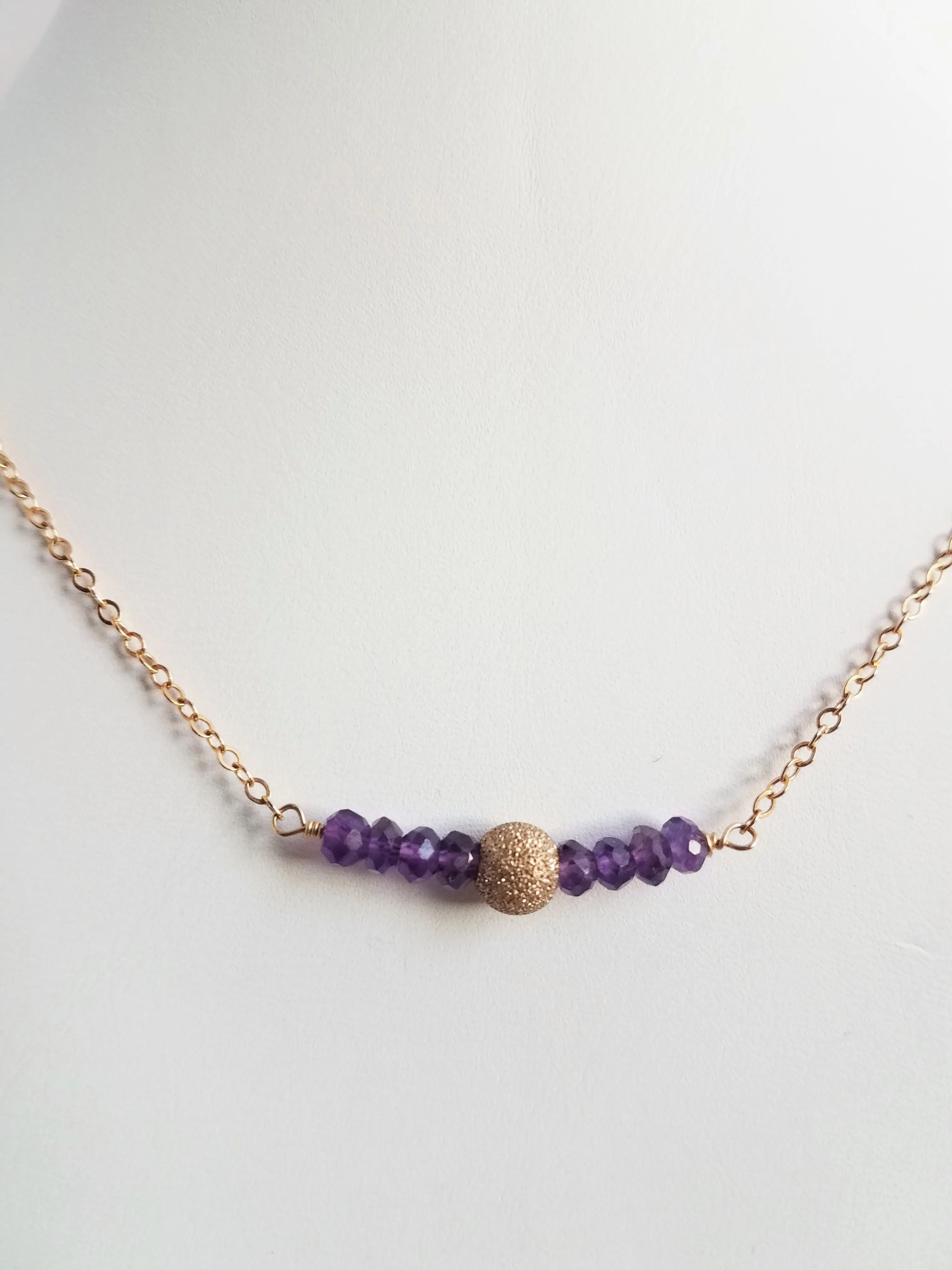 Delicate Bar Necklace Features Faceted Amethyst Surrounded By a Gold-Filled Sparkle Ball To Form a Slight Curved Bar Raises Spiritual Consciousness On Gold-filled Chain.