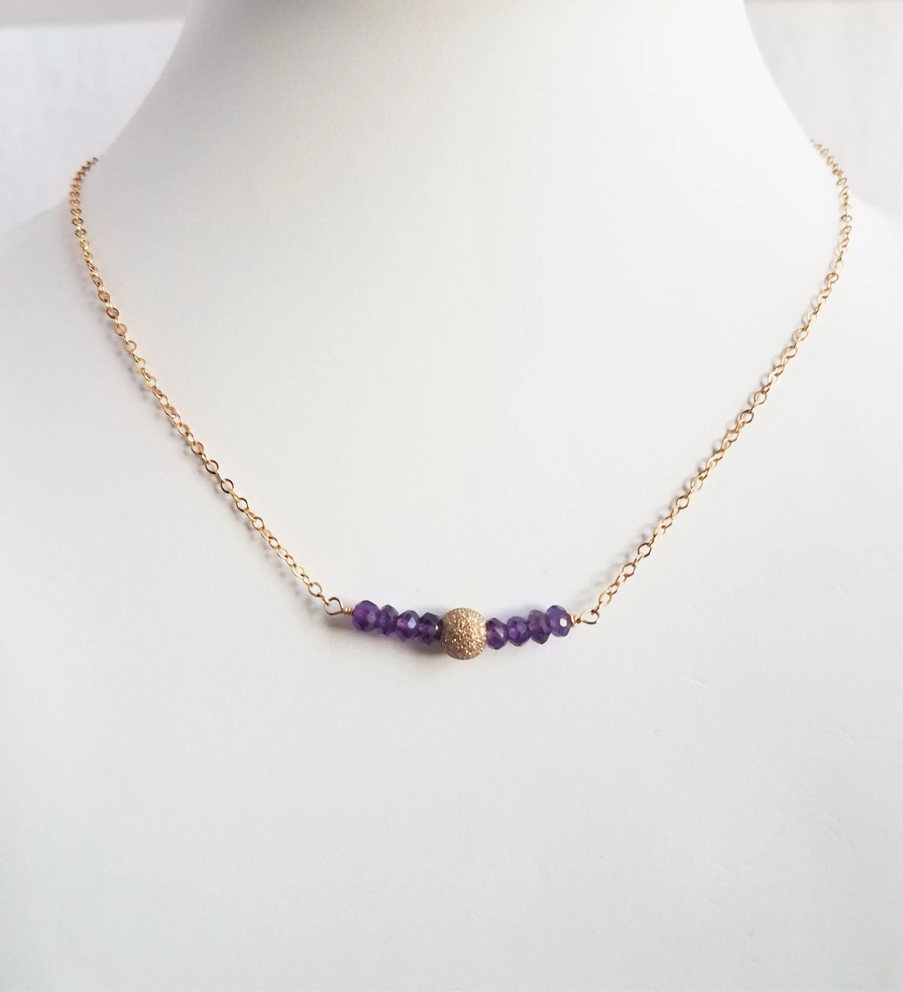 Delicate Bar Necklace Features Faceted Amethyst Surrounded By a Gold-Filled Sparkle Ball To Form a Slight Curved Bar Raises Spiritual Consciousness On Gold-filled Chain.