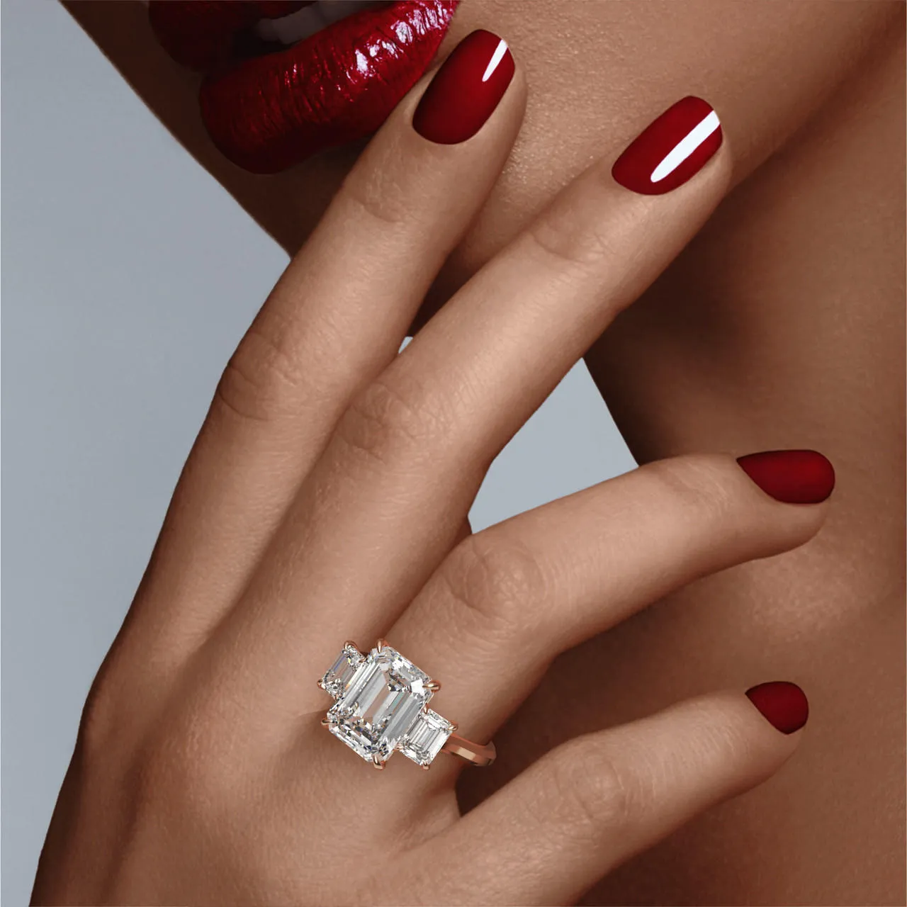 EMERALD CUT DIAMOND ENGAGEMENT RING WITH A THREE STONE THREE PHASES SLIM SETTING IN 18K ROSE GOLD