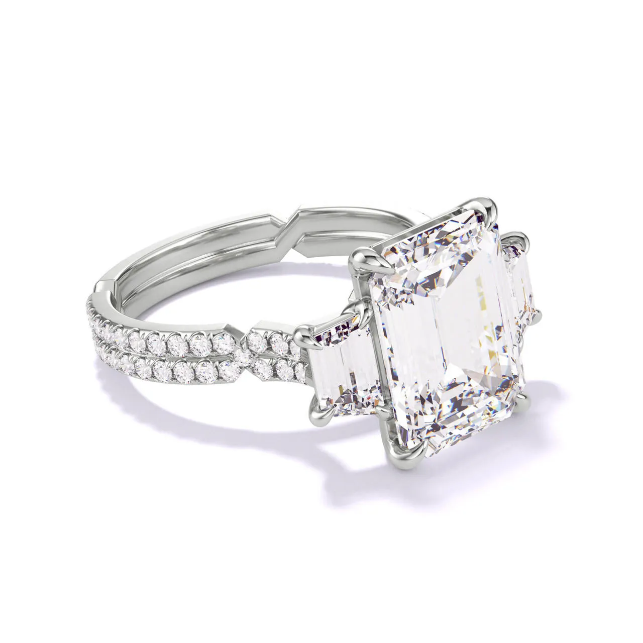 EMERALD CUT DIAMOND ENGAGEMENT RING WITH A TRAPEZOID FLANK CHANCE PAVE SETTING IN PLATINUM