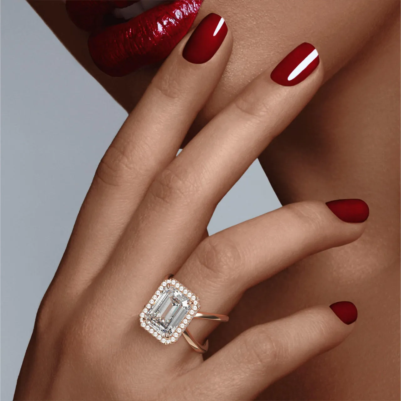 EMERALD CUT DIAMOND ENGAGEMENT RING WITH A WRAPPED HALO AXIS SETTING IN 18K ROSE GOLD