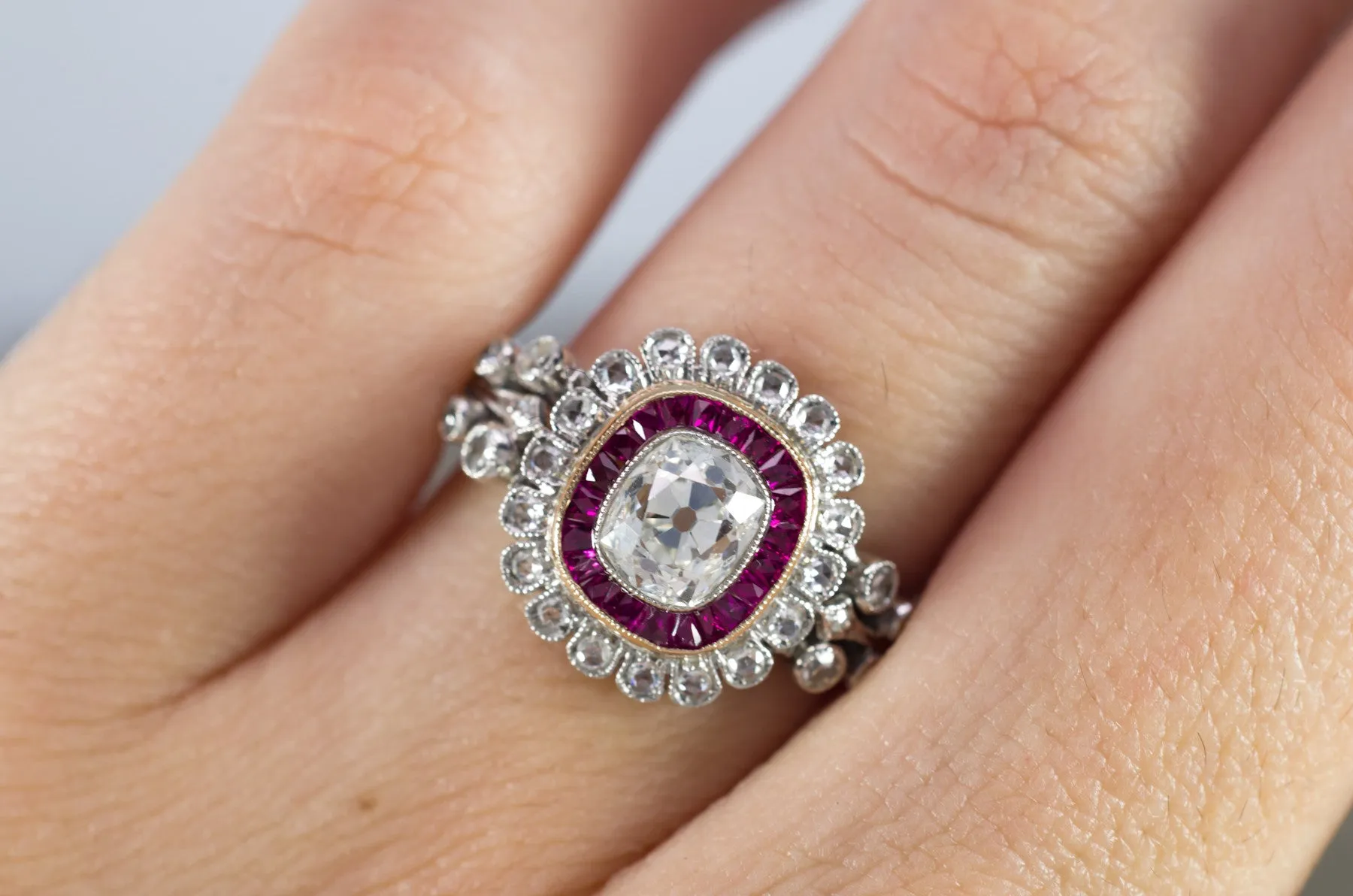 OLD CUSHION CUT DIAMOND AND RUBY HALO RING