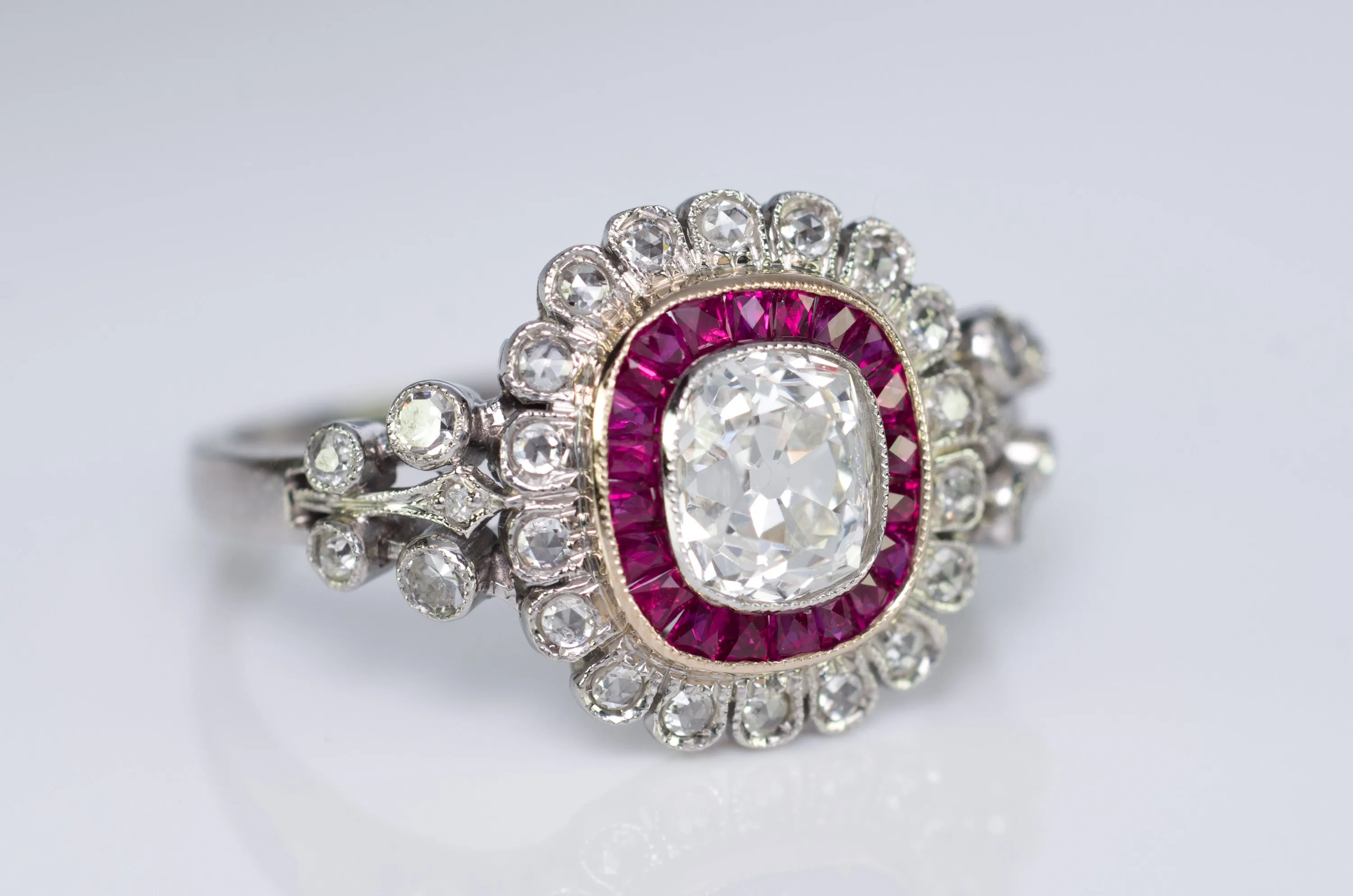 OLD CUSHION CUT DIAMOND AND RUBY HALO RING