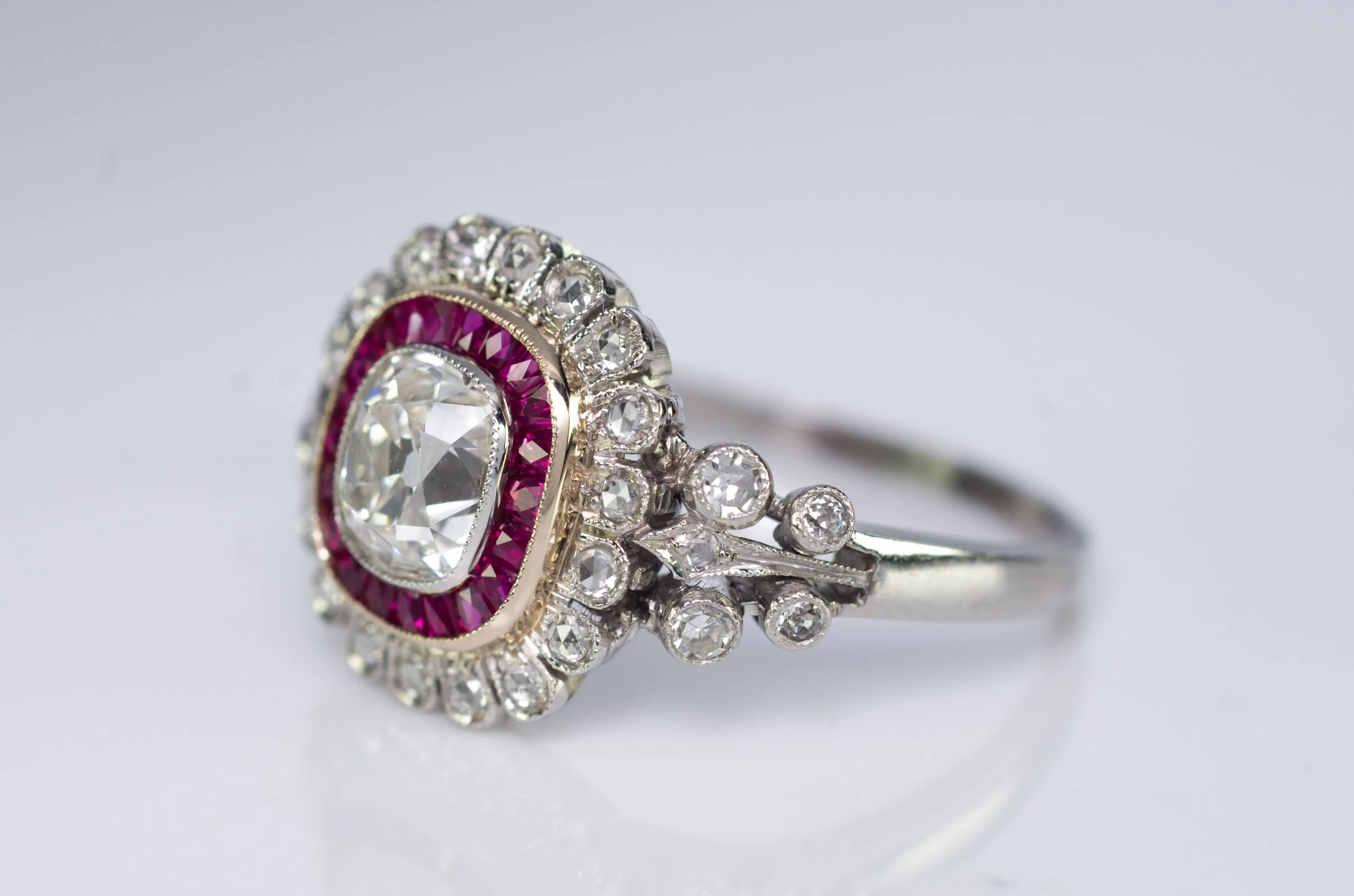 OLD CUSHION CUT DIAMOND AND RUBY HALO RING