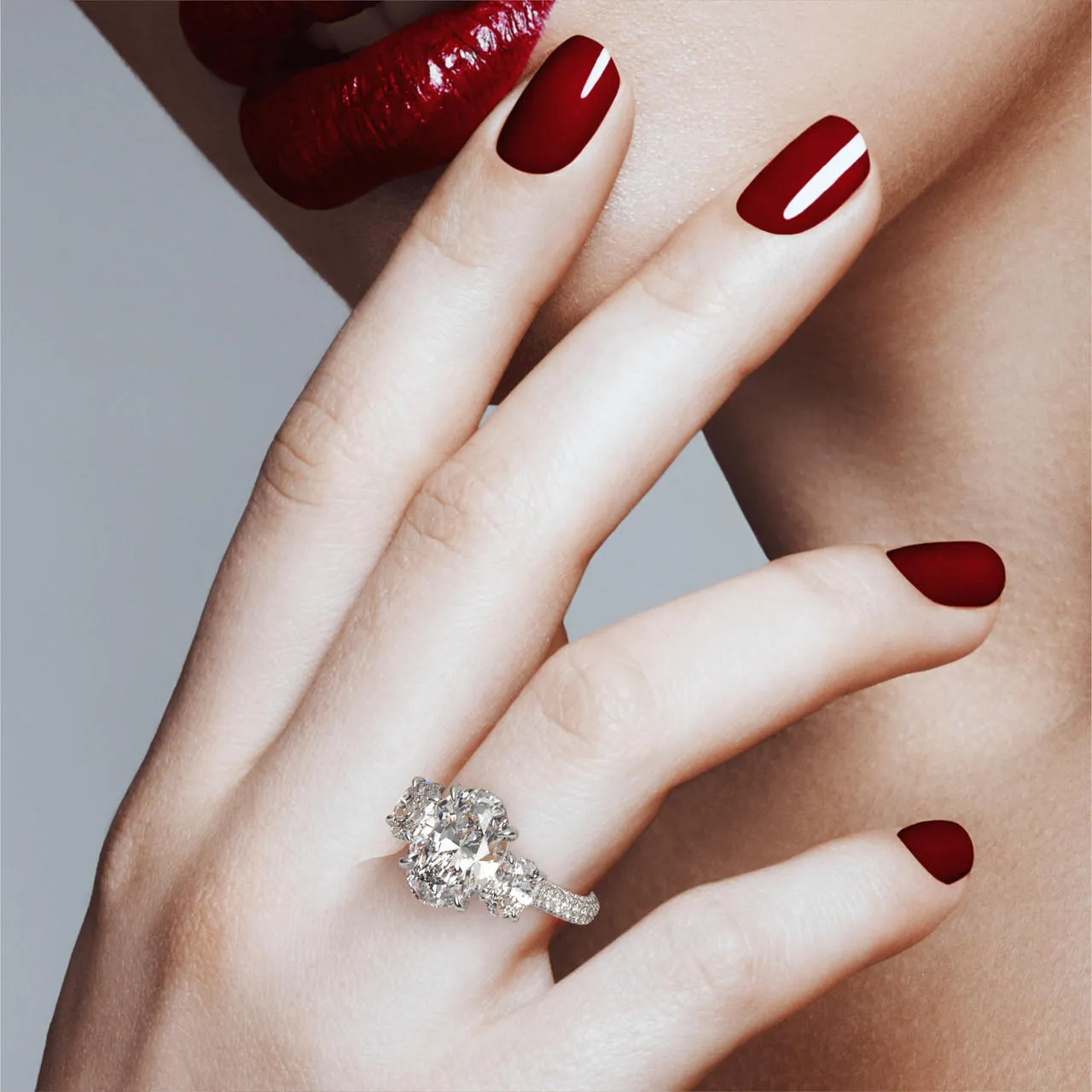 OVAL CUT DIAMOND ENGAGEMENT RING WITH A THREE STONE THREE PHASES TRIPLE PAVE SETTING IN PLATINUM