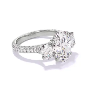 OVAL CUT DIAMOND ENGAGEMENT RING WITH A THREE STONE THREE PHASES TRIPLE PAVE SETTING IN PLATINUM