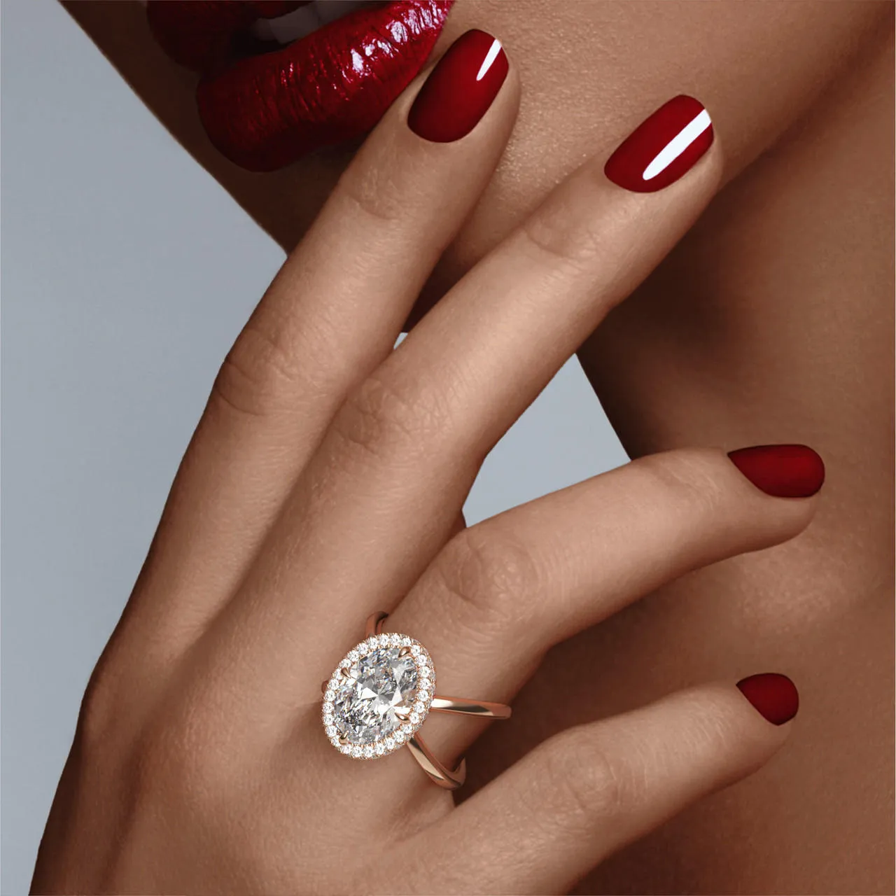 OVAL CUT DIAMOND ENGAGEMENT RING WITH A WRAPPED HALO AXIS SETTING IN 18K ROSE GOLD